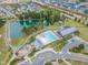 Aerial view of the community amenities featuring a pool, pond, clubhouse, playground, and lush green spaces at 1920 Bright Kannon Way, Wendell, NC 27591