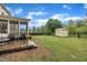 Spacious backyard with a screened-in porch, deck, a storage shed, and a lush green lawn, offering plenty of space at 1920 Bright Kannon Way, Wendell, NC 27591