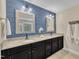Stylish bathroom features a blue accent wall, double sinks, and granite countertops at 1920 Bright Kannon Way, Wendell, NC 27591
