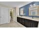 Stylish bathroom features a blue accent wall, double sinks, and granite countertops at 1920 Bright Kannon Way, Wendell, NC 27591