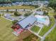 Aerial view of a neighborhood clubhouse and pool with patio seating, umbrellas, and a parking lot, surrounded by homes at 1920 Bright Kannon Way, Wendell, NC 27591