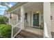 Inviting front porch with brick steps, white columns, and a charming green front door at 1920 Bright Kannon Way, Wendell, NC 27591