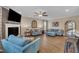 Spacious living room featuring a fireplace, ceiling fan, and comfortable blue sofas at 1920 Bright Kannon Way, Wendell, NC 27591