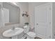 Stylish powder room featuring modern fixtures, a decorative mirror, and neutral tones at 1920 Bright Kannon Way, Wendell, NC 27591
