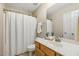 Bathroom featuring white shower curtain and vanity with framed mirror providing a serene atmosphere at 1984 Sadler Ave, Creedmoor, NC 27522