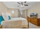 Comfortable bedroom featuring neutral walls, ceiling fan, and a dresser with television at 1984 Sadler Ave, Creedmoor, NC 27522