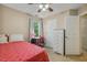 Comfortable bedroom featuring a ceiling fan, desk and chair and light neutral paint at 1984 Sadler Ave, Creedmoor, NC 27522