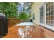 Well kept wood deck featuring an outdoor grill, chairs, table and backing to the yard at 1984 Sadler Ave, Creedmoor, NC 27522