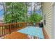 Well kept wood deck featuring an outdoor grill, chairs, table and backing to the yard at 1984 Sadler Ave, Creedmoor, NC 27522