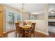 Bright dining room with wood table and chairs near French doors and adjacent to living room at 1984 Sadler Ave, Creedmoor, NC 27522