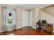 Welcoming entryway featuring hardwood floors, a window with curtains, and a functional workstation at 1984 Sadler Ave, Creedmoor, NC 27522