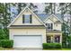 Charming home featuring a two-car garage, manicured lawn, and traditional architectural details at 1984 Sadler Ave, Creedmoor, NC 27522