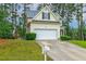 Two-story home boasts an attached two-car garage, front yard, mature trees, and a classic mailbox at 1984 Sadler Ave, Creedmoor, NC 27522