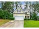 Traditional home with a well-maintained lawn and driveway leading to an attached two-car garage at 1984 Sadler Ave, Creedmoor, NC 27522