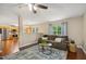 Bright living room with hardwood floors, a modern ceiling fan, and a view into the kitchen at 1984 Sadler Ave, Creedmoor, NC 27522