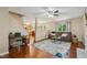 Inviting living room features hardwood floors, neutral paint, a ceiling fan, and a comfortable seating area at 1984 Sadler Ave, Creedmoor, NC 27522