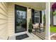 Inviting porch featuring stylish seating, a decorative door, and a 'Home Sweet Home' welcome mat at 1984 Sadler Ave, Creedmoor, NC 27522
