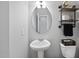 Modern bathroom features pedestal sink, decorative shelves, and updated fixtures at 200 Gill Farm Way, Franklinton, NC 27525