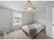 A bright bedroom features carpeted floors, a bed and a window at 200 Gill Farm Way, Franklinton, NC 27525