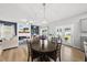 Open concept living area and dining room features a modern electric fireplace and hardwood floors at 200 Gill Farm Way, Franklinton, NC 27525