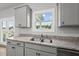 Modern kitchen features granite countertops and stainless steel sink under a sunny window at 200 Gill Farm Way, Franklinton, NC 27525