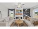 Charming living room with an electric fireplace, ceiling fan, and cozy seating arrangement for relaxing at 200 Gill Farm Way, Franklinton, NC 27525
