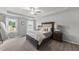 Spacious main bedroom featuring plush carpet, large windows and a tray ceiling with a ceiling fan at 200 Gill Farm Way, Franklinton, NC 27525