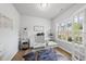 Bright home office with hardwood floors, modern desk, open shelving and natural light at 200 Gill Farm Way, Franklinton, NC 27525