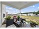 Enjoyable patio with a grill, seating, and a view of the open backyard at 200 Gill Farm Way, Franklinton, NC 27525