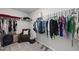 A walk-in closet contains shelving with hanging clothes and a small chair at 200 Gill Farm Way, Franklinton, NC 27525