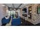 A community living room featuring comfortable seating, a decorative fireplace, and shelving at 200 Seagraves Creek Ln, Holly Springs, NC 27540