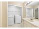 Bathroom featuring a washing machine, dryer, and vanity sink at 2015 Walnut St, Durham, NC 27705