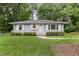 Charming single story home featuring gray siding, white trim, and manicured landscaping at 2015 Walnut St, Durham, NC 27705