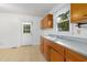 Practical kitchen with wood cabinets, ample counter space, and a door offering access to the outdoors at 2015 Walnut St, Durham, NC 27705