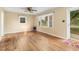 Inviting living room featuring hardwood floors, a ceiling fan, and natural light streaming through the windows at 2015 Walnut St, Durham, NC 27705