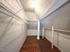 View of the attic featuring wire shelving and wood floors at 208 Glenn St, Franklinton, NC 27525