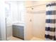 Bathroom featuring a shower with white tile and a vanity with a gray cabinet at 208 Glenn St, Franklinton, NC 27525