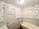 Charming bathroom with vintage-style fixtures and fish wallpaper at 208 Glenn St, Franklinton, NC 27525