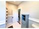 A bathroom featuring a cabinet with shelves and a view of the staircase outside the doorway at 208 Glenn St, Franklinton, NC 27525