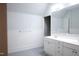 Bathroom featuring wainscoting, a large mirror, and a double sink vanity at 208 Glenn St, Franklinton, NC 27525