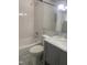 A bathroom featuring a shower and tub with a gray cabinet and a marble countertop at 208 Glenn St, Franklinton, NC 27525