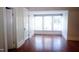 Bright bedroom showcasing a large window, wood floors, and fresh paint at 208 Glenn St, Franklinton, NC 27525