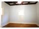 Bedroom featuring hardwood floors, a coffered ceiling, and natural lighting at 208 Glenn St, Franklinton, NC 27525