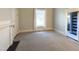 A bedroom featuring carpet, neutral paint, and white trim with an attached bathroom at 208 Glenn St, Franklinton, NC 27525