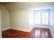 Bright bedroom with charming shuttered windows and hardwood floors at 208 Glenn St, Franklinton, NC 27525