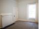 Neutral bedroom with white trim, fireplace and plush carpet at 208 Glenn St, Franklinton, NC 27525