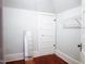 Bright bedroom featuring neutral paint, wire shelving, and hardwood floors at 208 Glenn St, Franklinton, NC 27525