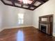 Bedroom showcasing hardwood floors, fireplace, and a window with natural light at 208 Glenn St, Franklinton, NC 27525