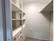Walk-in closet with built-in shelving and drawers to keep clothes organized at 208 Glenn St, Franklinton, NC 27525
