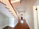 Charming foyer with hardwood floors and red-trimmed staircase, enhanced by natural light at 208 Glenn St, Franklinton, NC 27525